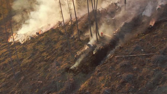 4k aerial drone shot - extinguishing a forrest fire during sunset - nice color cinematic footage