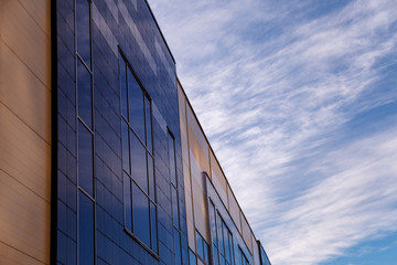The modern facade of the office building is an abstract fragment, with shiny Windows in a steel structure. Great background for a business card, flyer, banner with space for an inscription or logo