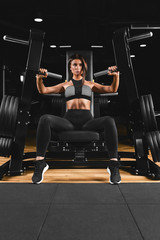 Fototapeta na wymiar Athletic woman doing triceps in the block, hand exercises. The girl in a comfortable tracksuit, has a slim, athletic figure, a strong, healthy body. Fitness Motivation