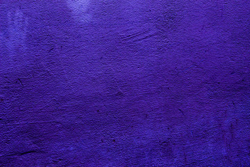 Purple colored abstract wall background with textures of different shades of purple or violet