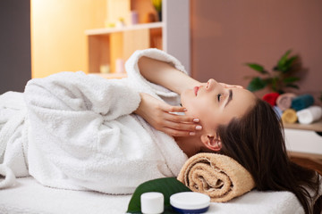 Young woman receiving cosmetic services in spa salon