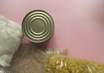 Cereals, various products, canned food, pasta and oil with place for text. Humanitarian assistance during the coronavirus pandemic