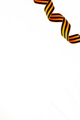 Curly St George ribbon isolated on white background. Symbol of victory on 9 may 1945 in USSR and Russia. Greeting card, copy space