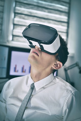 Businessman With VR Glasses Working In Office.