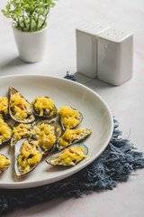 Stuffed Baked Mussels  (Baked Tahong) with Butter, Cheese and Garlic - zoom out with pepper and salt shaker 