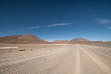 Sandy road through high Andean altiplano desert in Bolivia on Ruta de Las Lagunas