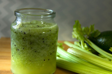 Fresh, healthy homemade green fruit and vegetable juice in a jar. Smoothie from celery sticks and kiwi. Green detox juice. Healthy eating concept.