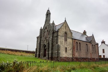 Fototapeta na wymiar Very old Auchmedden Church (Aberdour Church Of Scotland) in Pennan, Scotland in rainy and cloudy weather