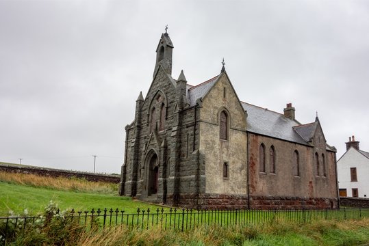 Very old Auchmedden Church (Aberdour Church Of Scotland) in Pennan, Scotland in rainy and cloudy weather