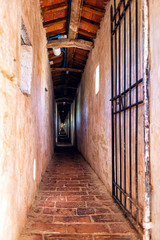 Fortress tunnel empty path passage with gate door in Castiglione del Lago in Italy with windows and shadows in historic town village fort