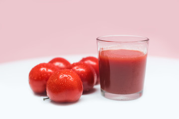 Fresh tomato juice and tomatoes on the background. A glass of freshly squeezed tomato juice. Healthy eating and healthy lifestyle.