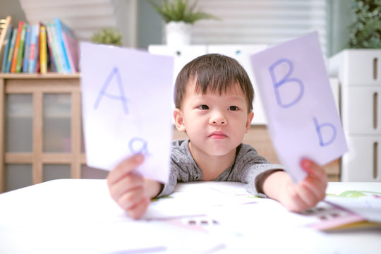 Kindergarten boy playing with flash cards , Asian children learning English with flash cards, Teach young kids English at home, Child at home, kindergarten closed during the Covid-19 health crisis