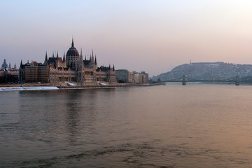 Fototapeta na wymiar The river Danube on a cold winter day with the Hungarian Parliament building in the background