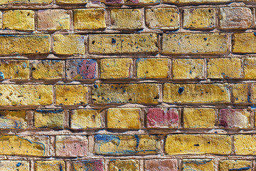 Brick wall design front center abstract closeup with golden gold yellow color and pattern in London, UK