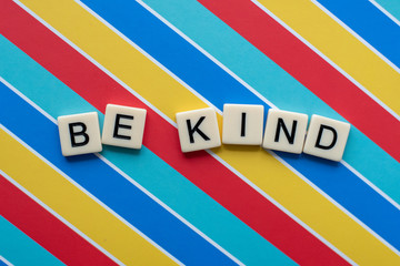 Be Kind Letter Tiles on colorful background