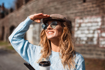 Emotional portrait of a happy and cheerful beautiful girl in a hat.