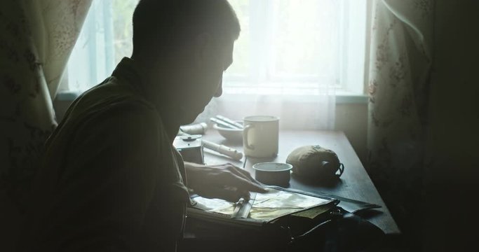 Scout hiding in rural house and planning attack strategy