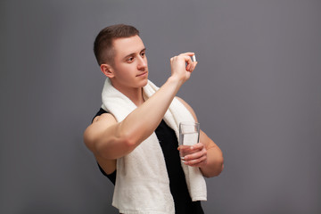 Man takes a pill of amino acids after training.