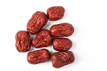 A bowl of Chinese dried red date fruit on white background.