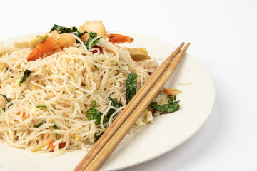 Homemade fish sauce fried bee hoon with few fresh prawn and vegetable on white background.
