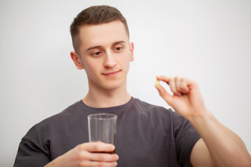 Man takes a pill of amino acids after training.