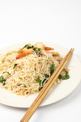 Homemade fish sauce fried bee hoon with few fresh prawn and vegetable on white background.