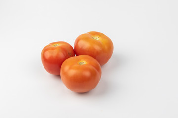 Fresh raw tomato isolated on white background.
