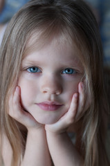 Portrait of a little girl with white hair and blue eyes