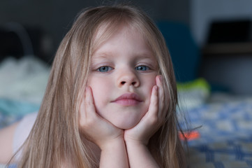 Portrait of a little girl with white hair and blue eyes