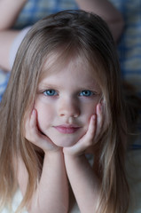 Portrait of a little girl with white hair and blue eyes