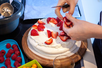 preparing pavlova cake at home female hands