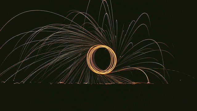 Wire Wool Spinning On Field At Night