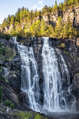Skjervsfossen norwegian landmark high powerful cascade waterfall. Nature travel clean falling water vertical landscape 