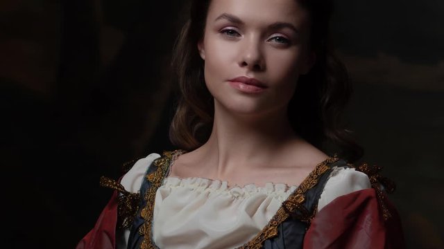 Portrait of a young woman in the style of a Renaissance painting. Beautiful mysterious girl in medieval dress