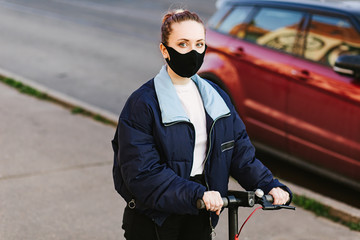woman with a protective mask with technological electric kick scooter