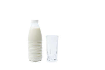 Full bottle of milk and an empty glass isolated on a white background