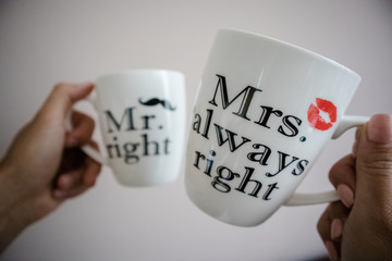 a young couple carrying white cups of tea or coffee with words Mr right and Mrs always right