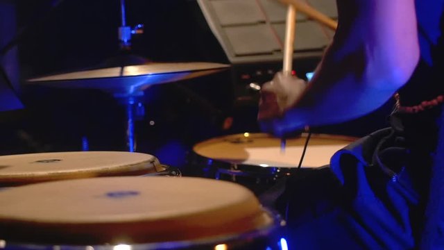 Rasta drummer playing on stage