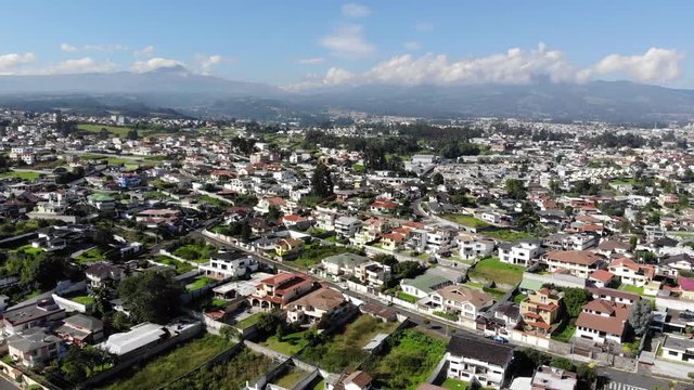 Aerial view over a suburb of Quito, Ecuador, the Valle de Los Chillos. Exceptionally clear sky and absence of smog due to lockdown over the  Coronavirus Covid-19 pandemic. 22 April 2020.