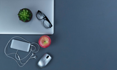 Teleworking grey desktop with mobile devices in flat lay format