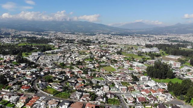 Aerial view over a suburb of Quito, Ecuador, the Valle de Los Chillos. Exceptionally clear sky and absence of smog due to lockdown over the  Coronavirus Covid-19 pandemic. 22 April 2020.
