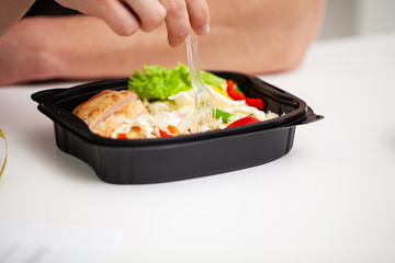 Close-up of a man holding a box full of protein rich foods for sports nutrition