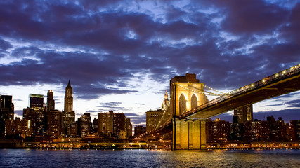 Brooklyn bridge with cloudy sky at night