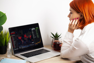 Woman with sadness watching the map of the spread of the coronavirus world