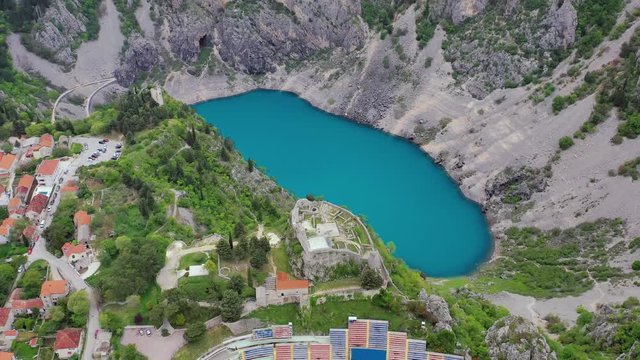 Famous and oval shaped blue lake and surrounding town, Imotski, Croatia. Aerial