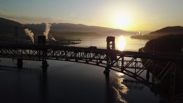 Vehicles Travelling On The Ironworkers Memorial Bridge In Vancouver, British Columbia On A Sunrise - Aerial Shot