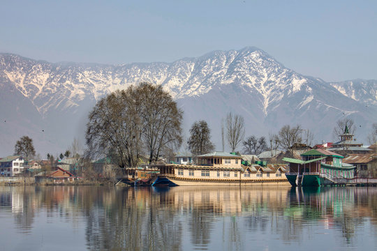 Houseboats on Dal Lake in Srinagar, summer capital of Jammu and Kashmir with Himalayan Mountains in background