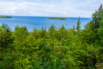 Fototapeta na wymiar Beautiful Northern Forest in front of a blue Lake Michigan and Small Island