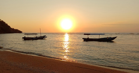 Fototapeta na wymiar boat with the sunset on the beach