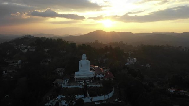 sunset in kandy sri lanka with the buddha statue